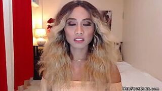 Asain blonde TS wanks cock in chair in front of webcam - porn video